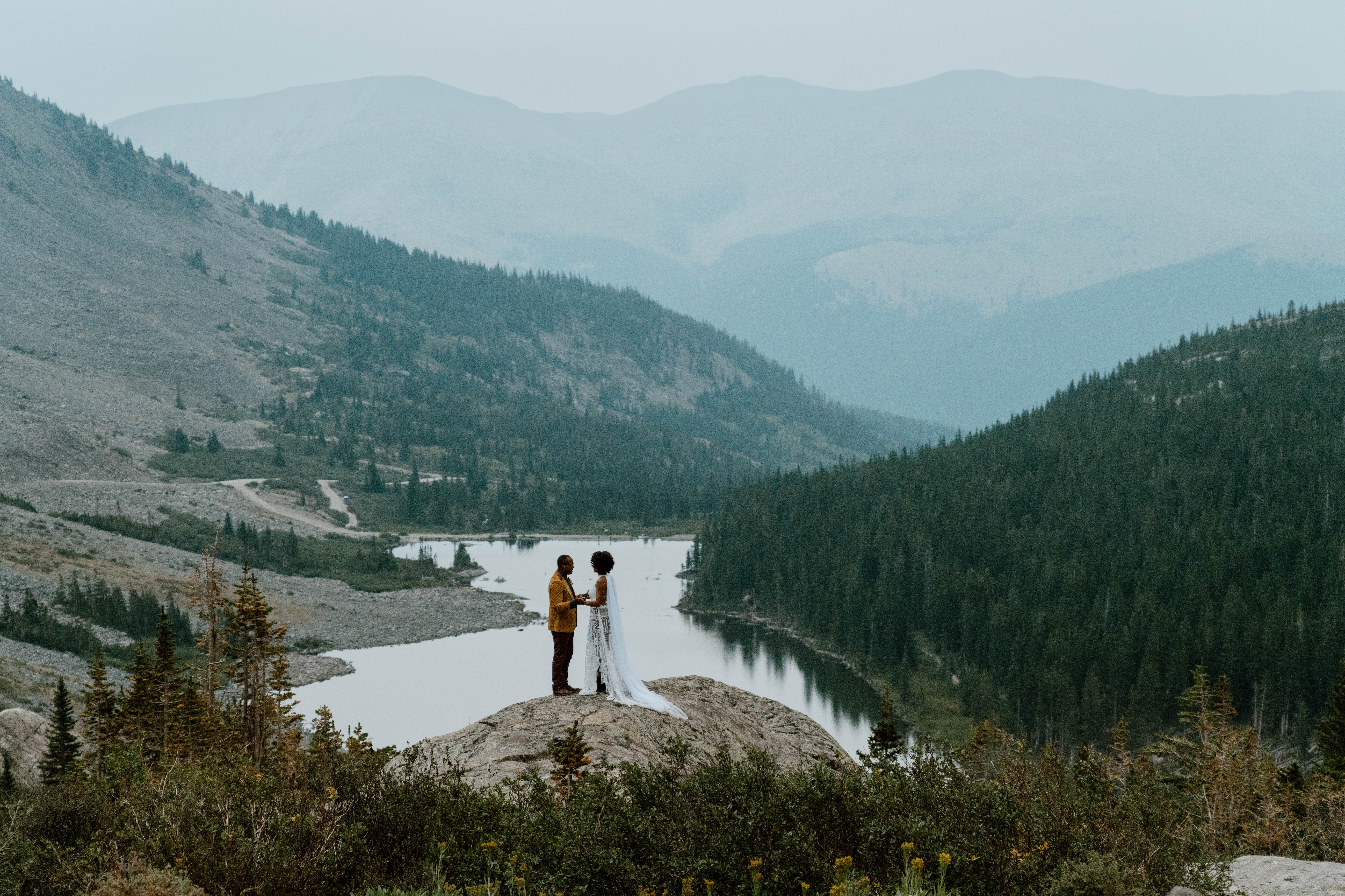 A couple in wedding attire celebrates their adventurous hiking elopement in Colorado