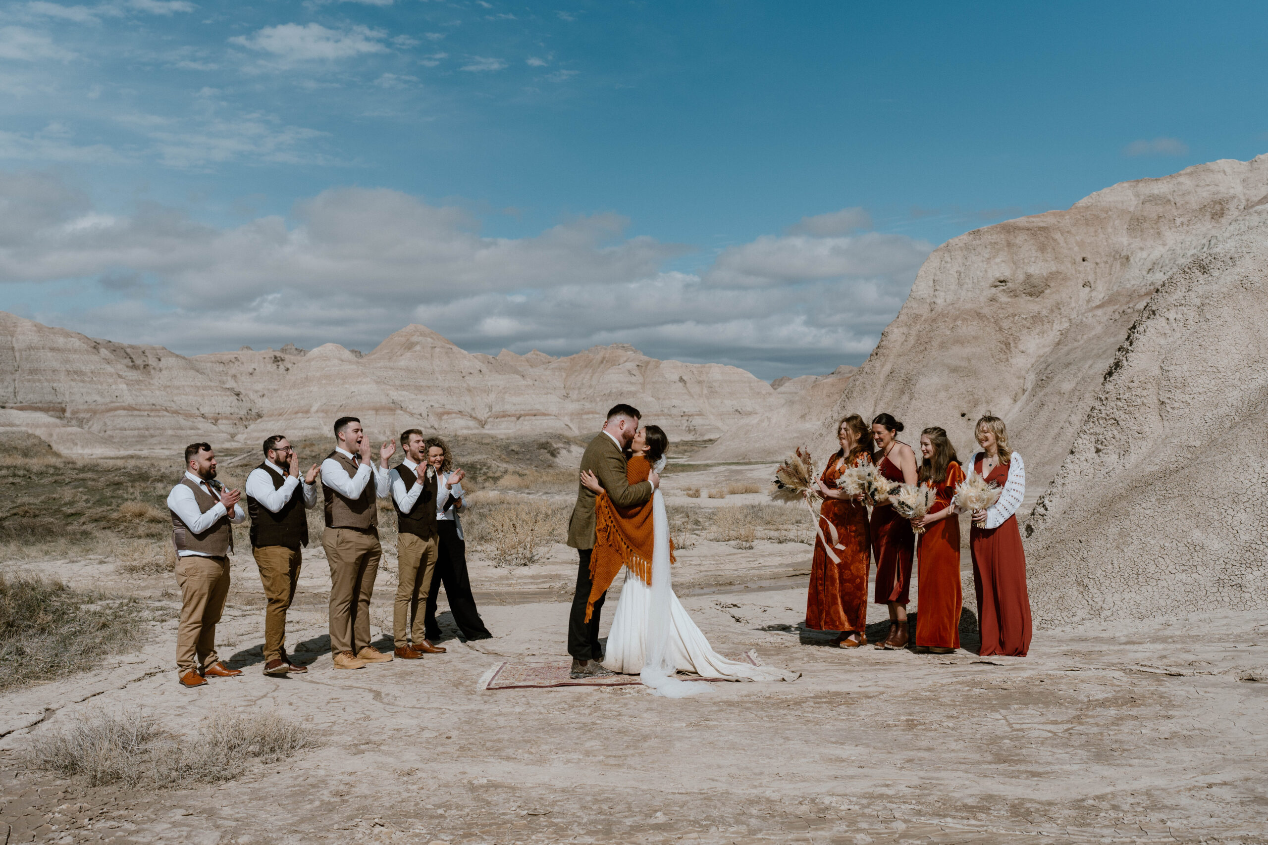 A couple celebrates their wedding ceremony with a kiss in Badlands National Park