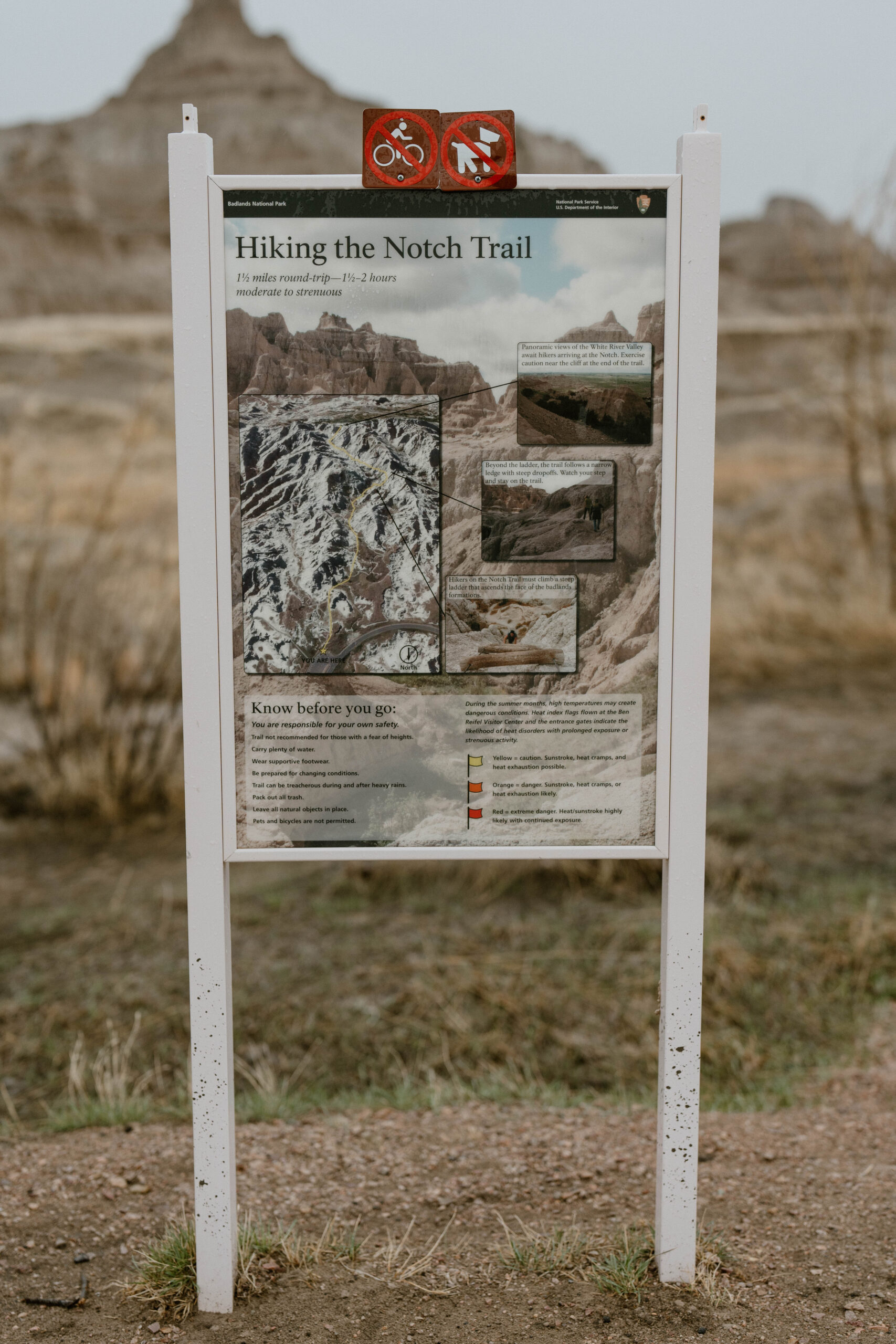 A sign of a hiking trail in Badlands National Park is pictured