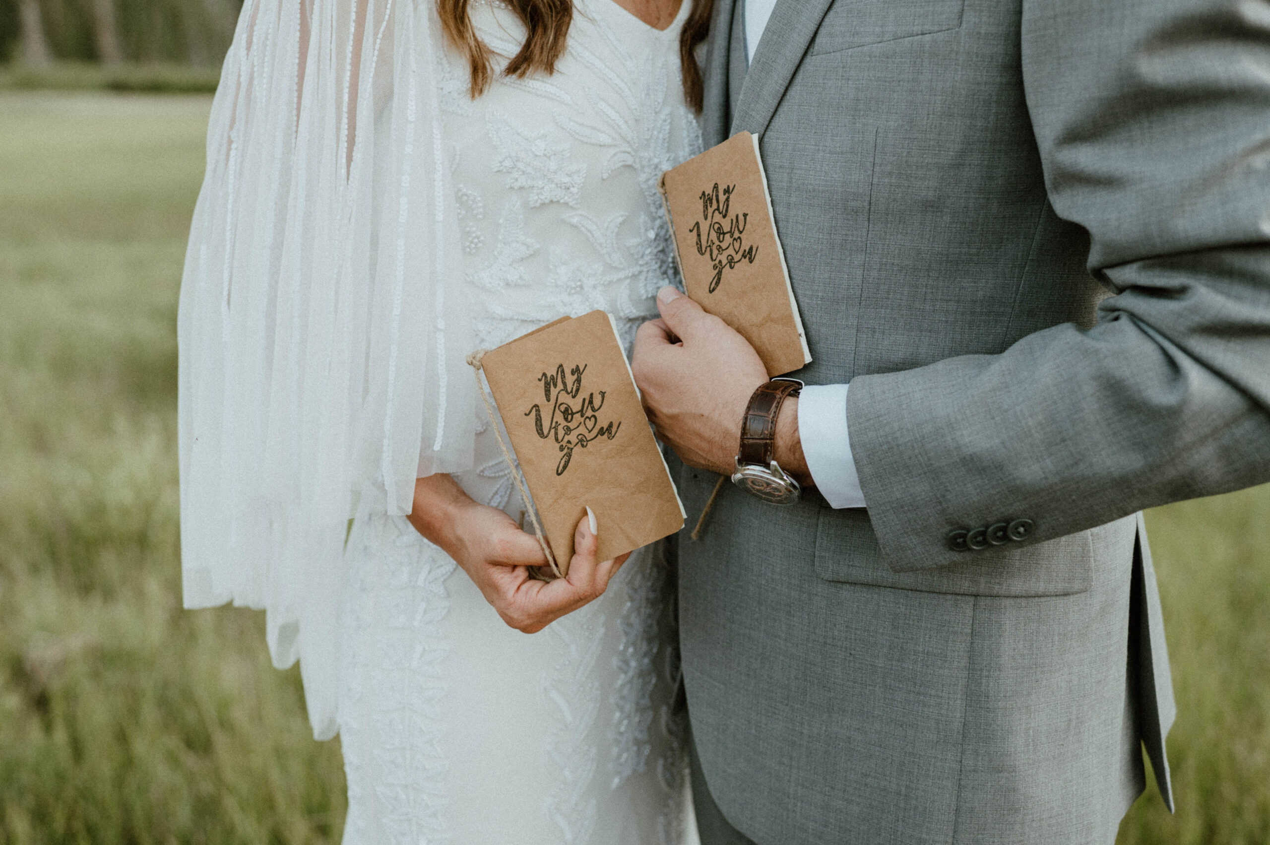 A couple holds a matching vow books during their Utah elopement