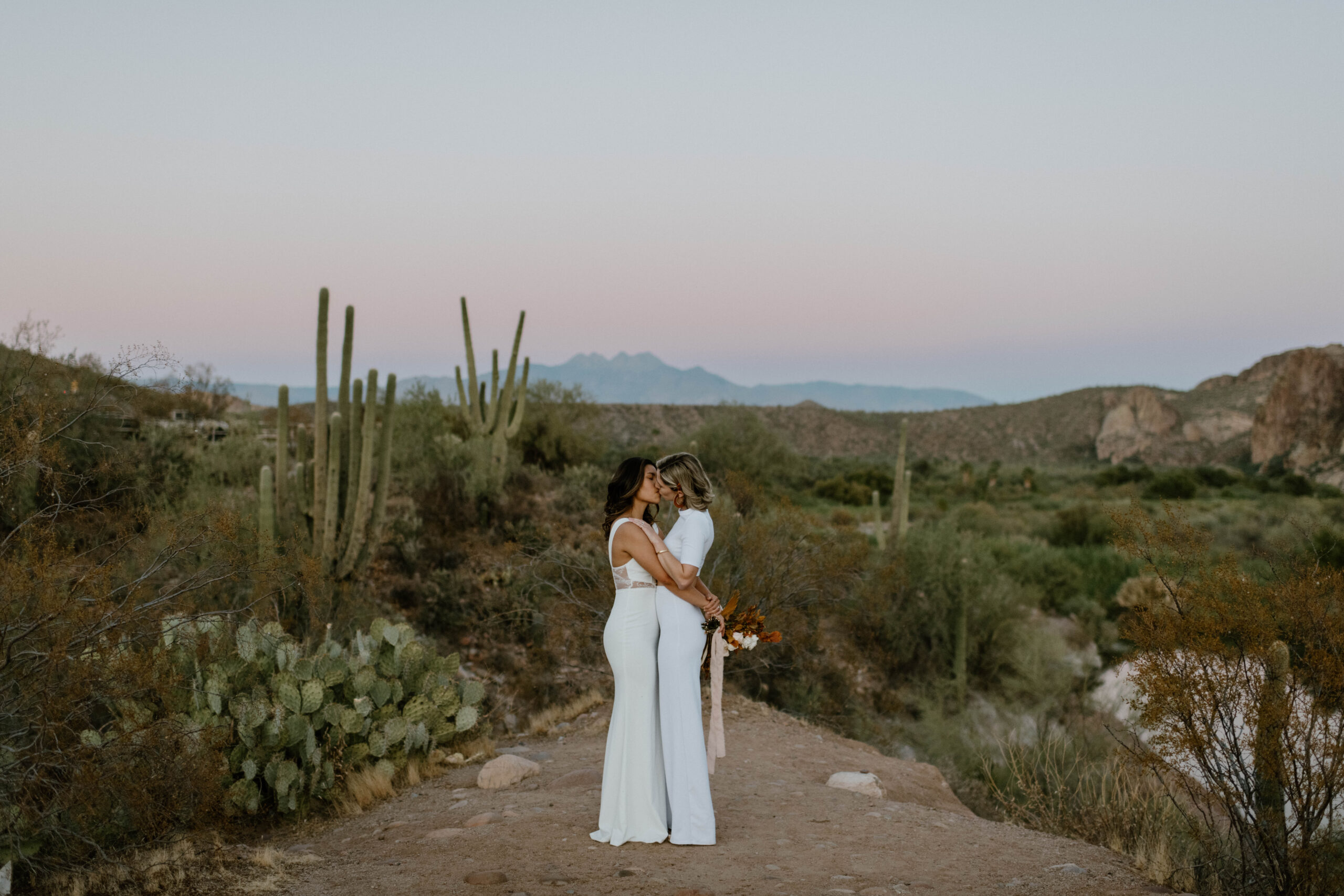 A couple leans in for a kiss during after their wedding vows in the desert